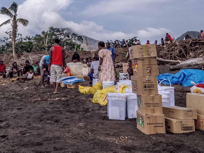 Food supplies from Greenpeace lining the seashore of Port Narvin Village, Erromango. Extreme weather events, such as Cyclone Pam, threaten to become the new normal for Pacific island states as the global climate changes, underscoring the urgency to cut global emissions to avert a climate crisis.